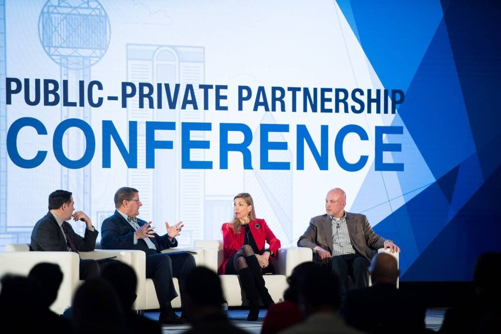 Conference panel having a discussion on stage